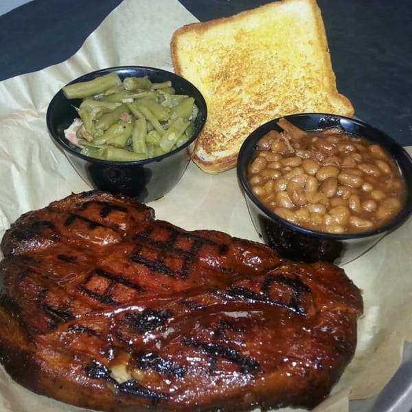 Doc's Smokehouse BBQ ribs with green beans, baked beans, and Texas toast.